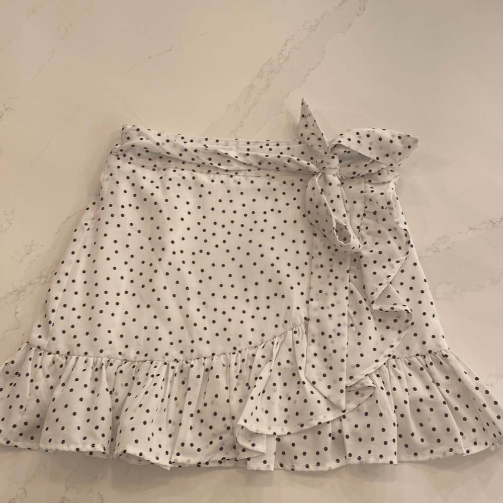 White with black polka dot skirt